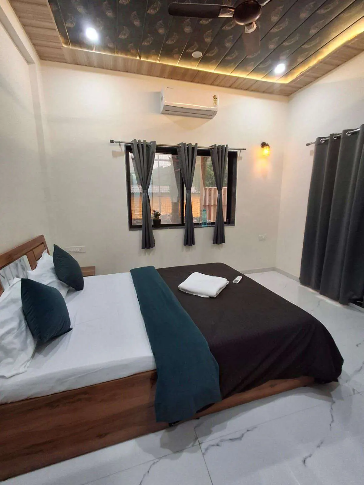 Air-conditioned bedroom in Shuubh Aavishkar 2BHK Villa, a 2 BHK villa in Lonavala on rent