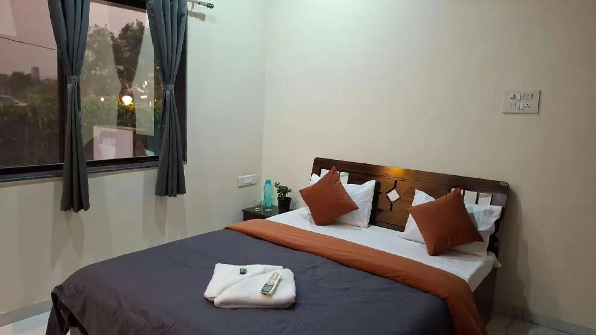 Air-conditioned bedroom in Shuubh Aavishkar 2BHK Villa, a 2 BHK villa in Lonavala on rent