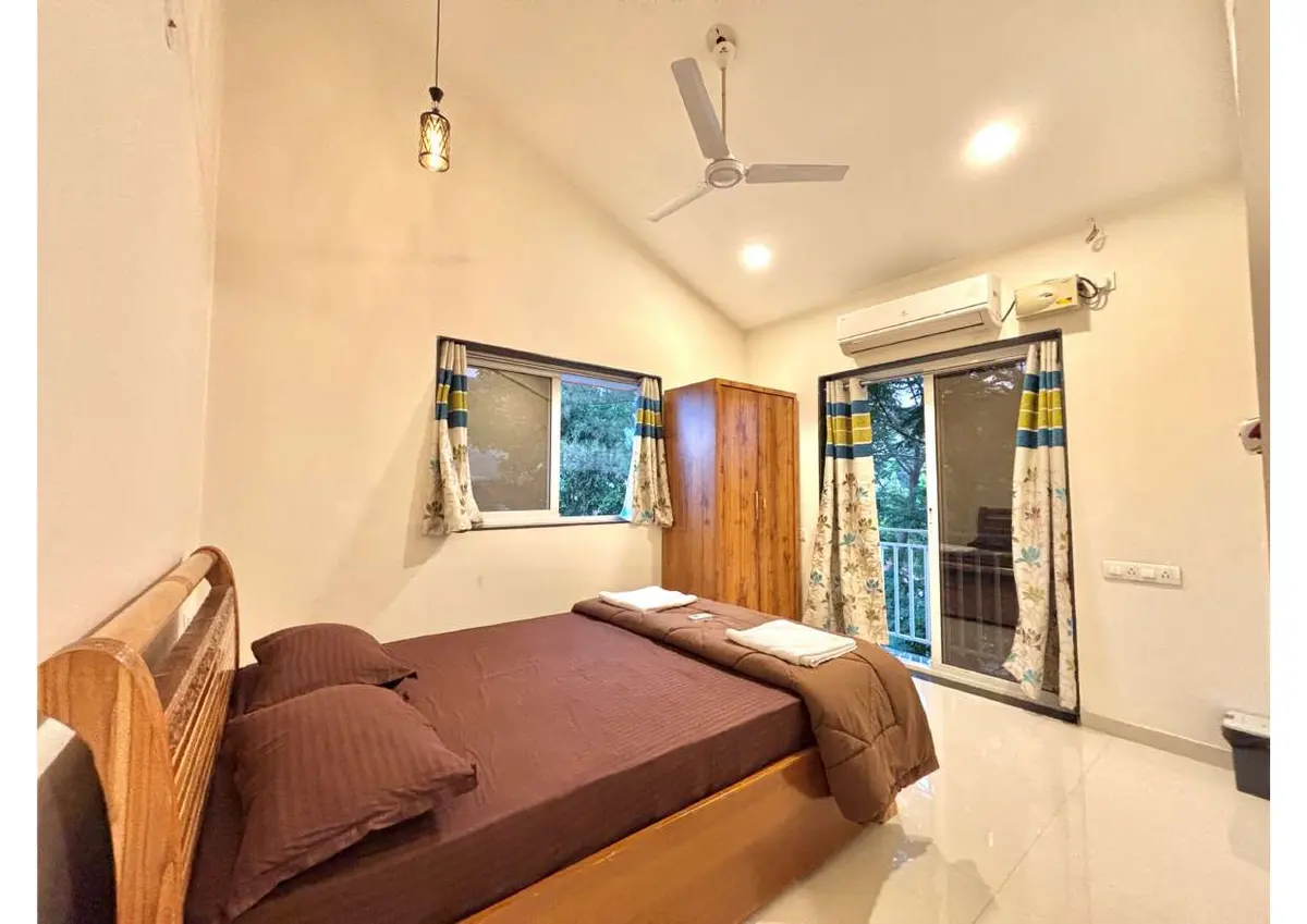 Air-conditioned bedroom in Duke's Nose Villa, a 4 BHK villa in Lonavala on rent