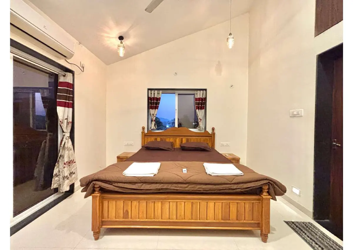 Air-conditioned bedroom in Duke's Nose Villa, a 4 BHK villa in Lonavala on rent