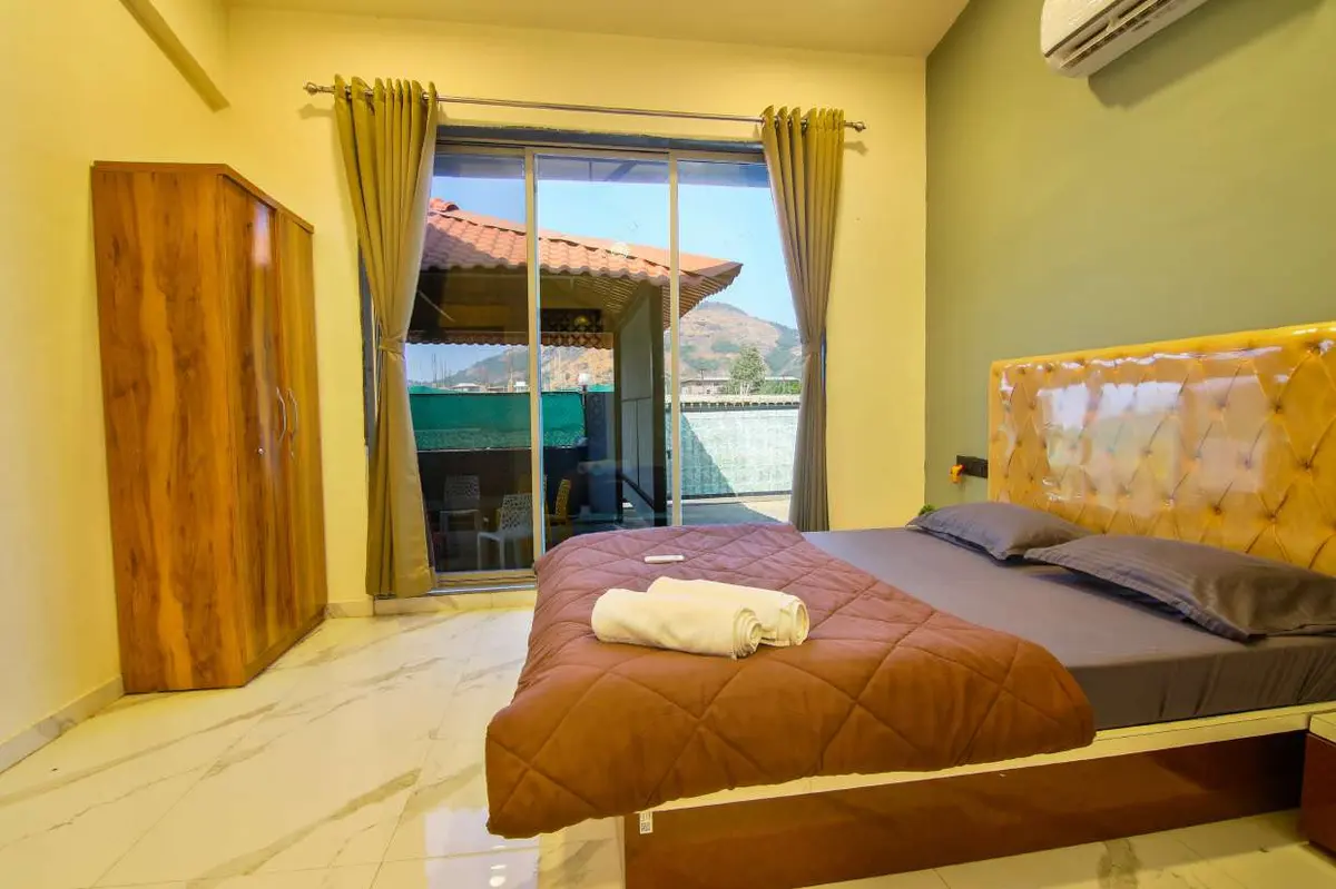 Air-conditioned bedroom in Shuubh Hillside 4BHK Villa, a 4 BHK villa in Lonavala on rent