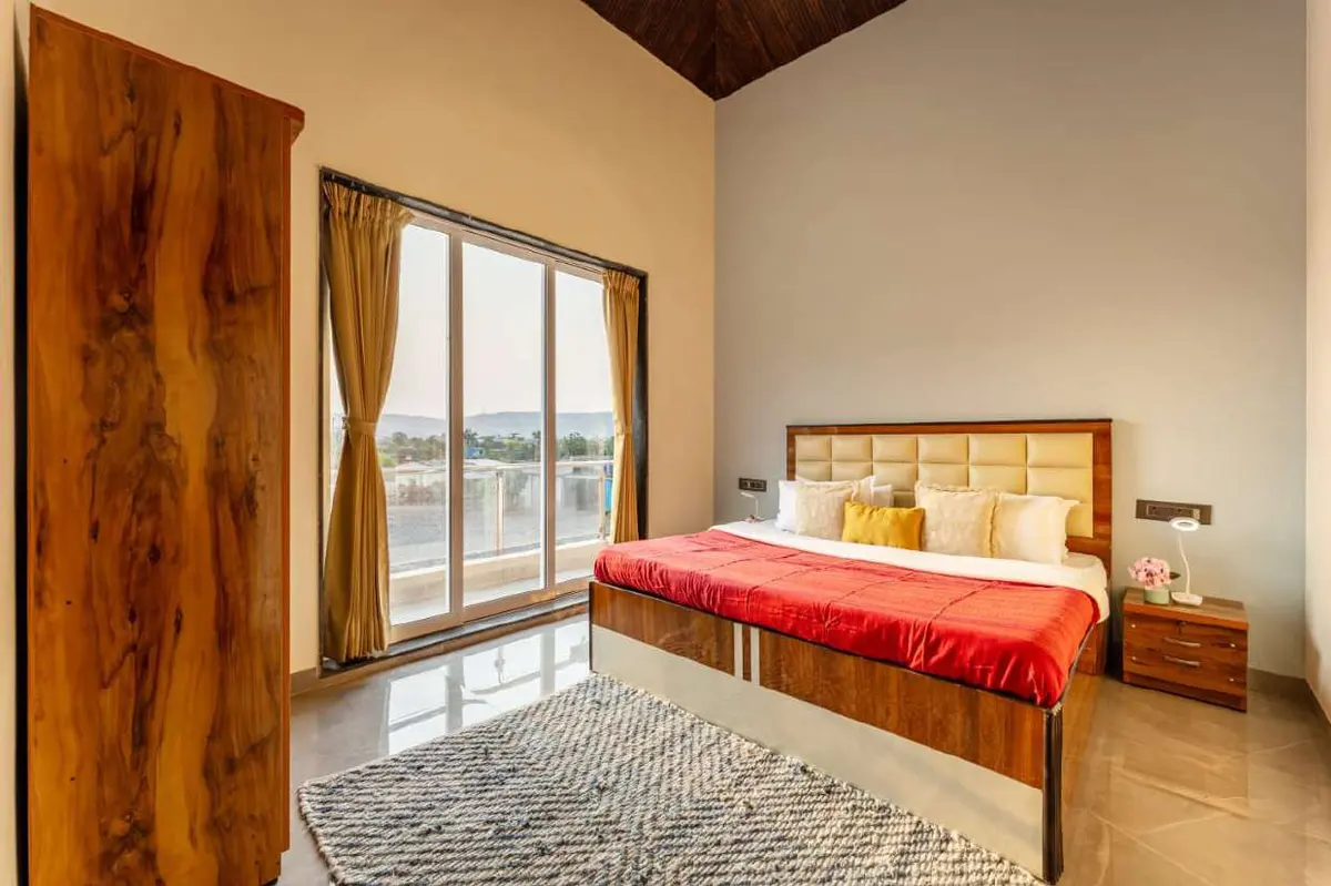 Air-conditioned bedroom in Shuubh Kaustubh 5BHK Villa, a 5 BHK villa in Lonavala on rent