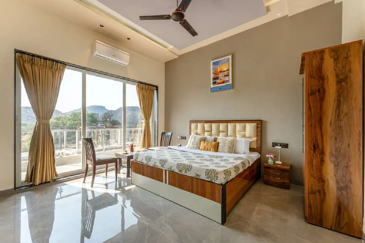 Air-conditioned bedroom in Shuubh Kaustubh 5BHK Villa, a 5 BHK villa in Lonavala on rent
