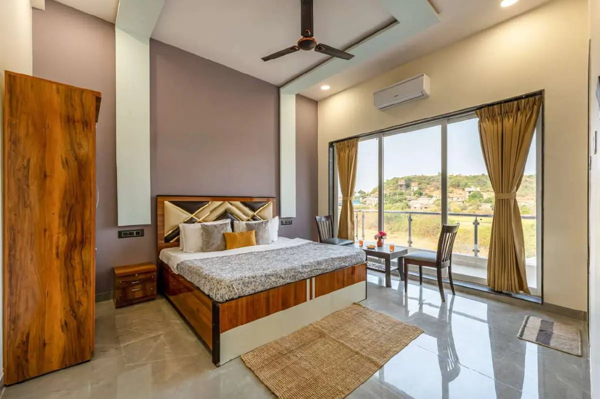 Air-conditioned bedroom in Shuubh Kaustubh 5BHK Villa, a 5 BHK villa in Lonavala on rent