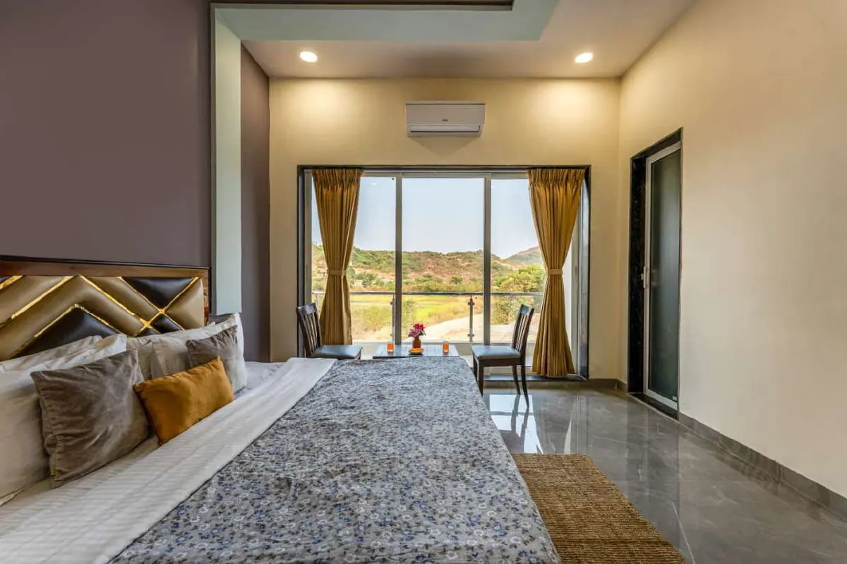 Air-conditioned bedroom in Shuubh Kaustubh 5BHK Villa, a 5 BHK villa in Lonavala on rent