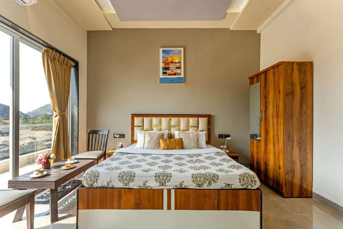 Air-conditioned bedroom in Shuubh Kaustubh 5BHK Villa, a 5 BHK villa in Lonavala on rent