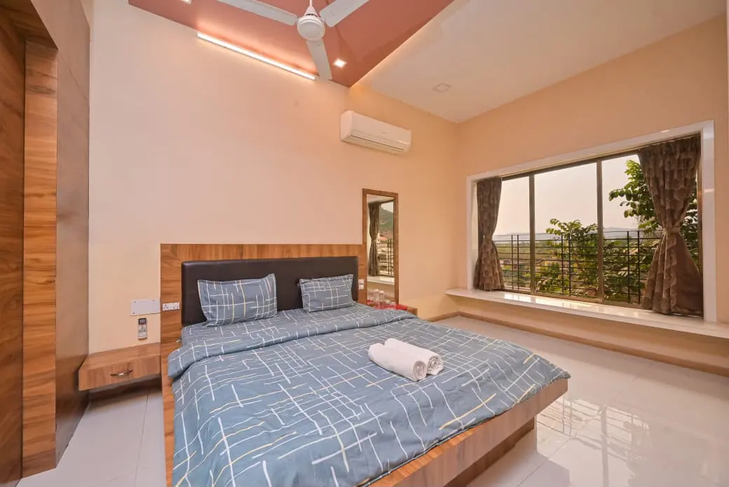 Air-conditioned bedroom in Shuubh Mountain Amber 5BHK Villa, a 5 BHK villa in Lonavala on rent