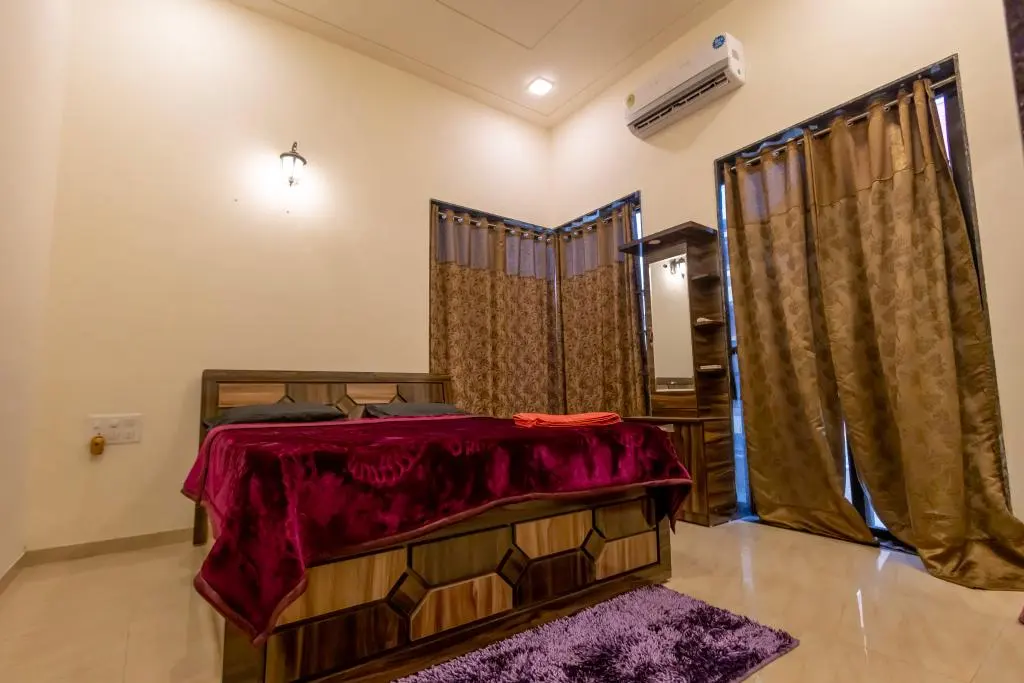 Air-conditioned bedroom in Rose Villa, a 4 BHK villa in Lonavala on rent