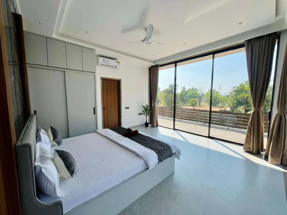 Air-conditioned bedroom in Vantara Villa, a 4 BHK villa in Lonavala on rent